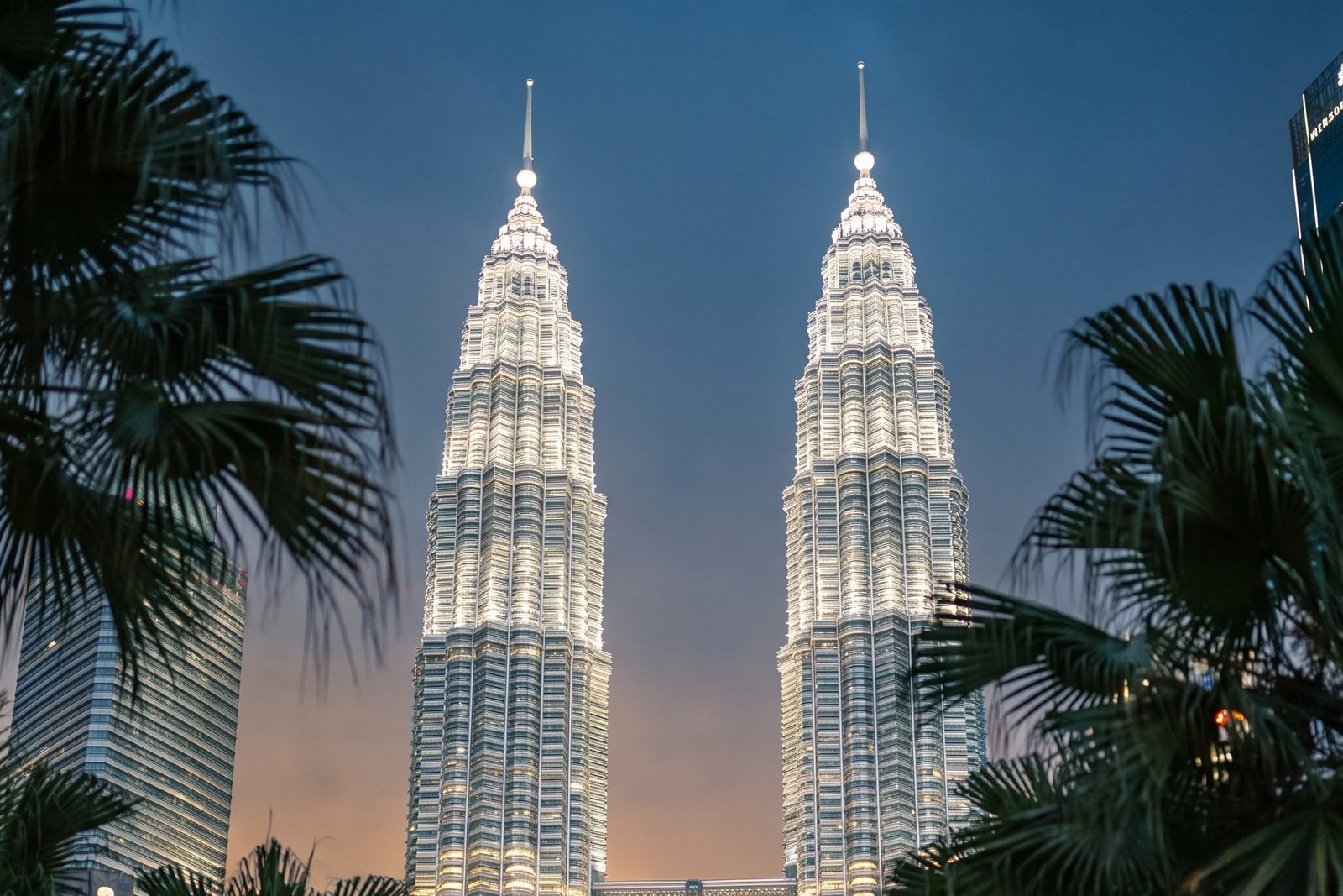 Illustration of the Petronas Twin Towers in Kuala Lumpur at dusk.