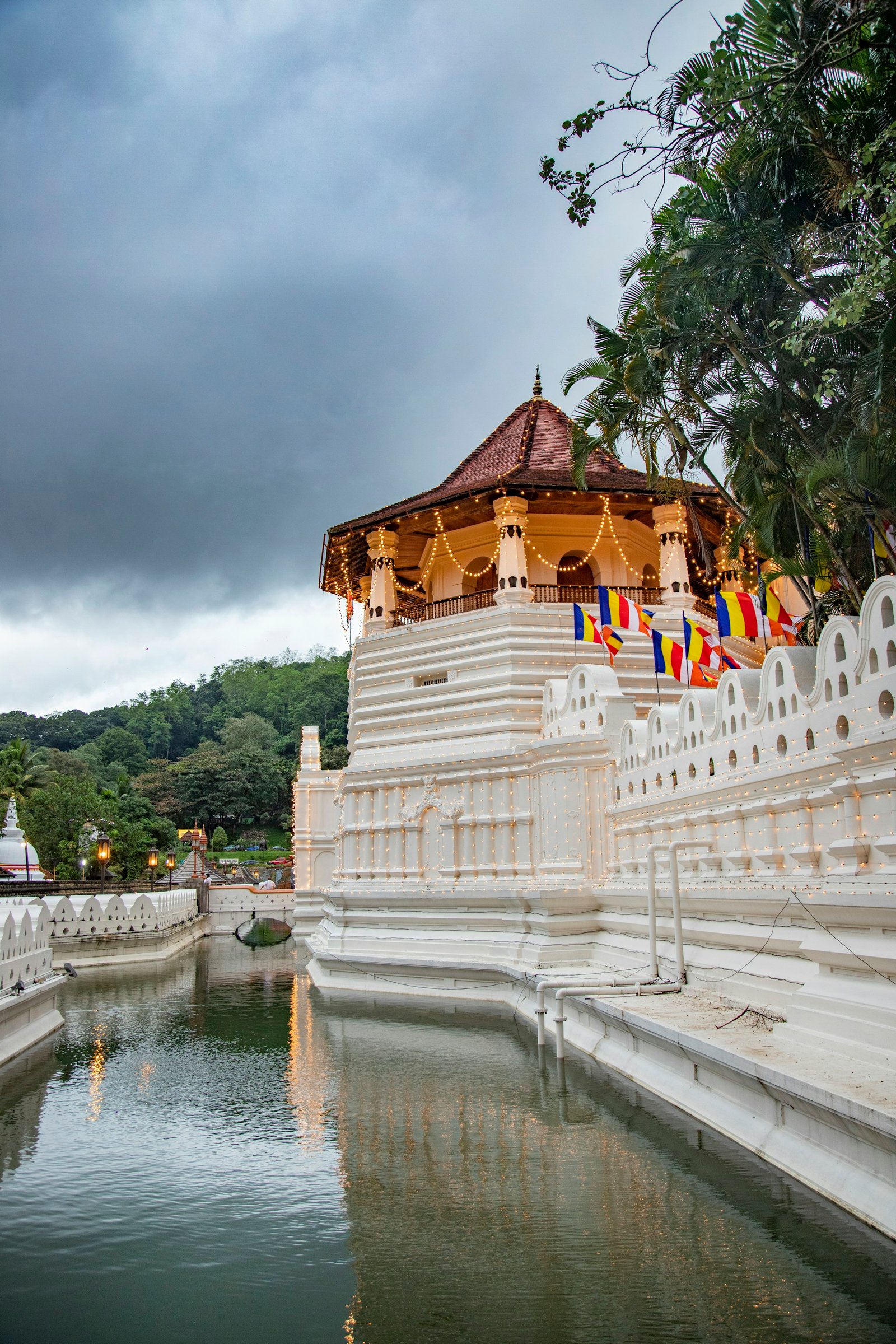 The Temple of the Sacred Tooth Relic beside the water in Kandy, Sri Lanka.