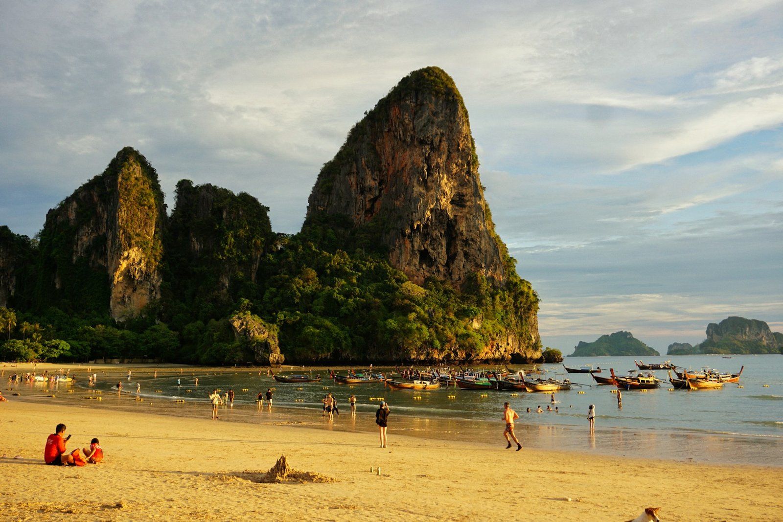 Boats and limestone cliffs at Railay Beach in Krabi, Thailand.