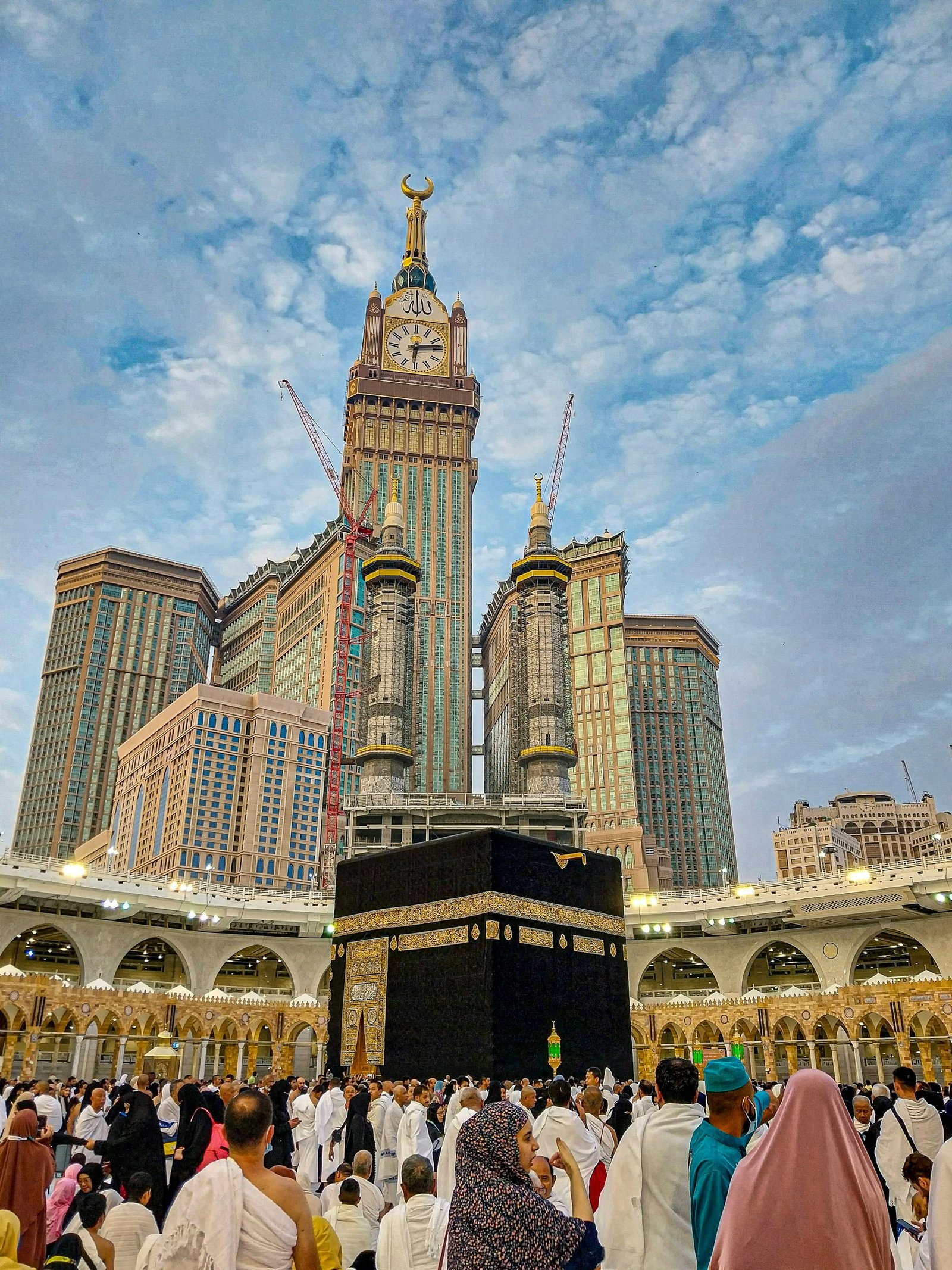 The Kaaba in the Masjid al-Haram courtyard in Makkah, with the Abraj Al-Bait towers behind.