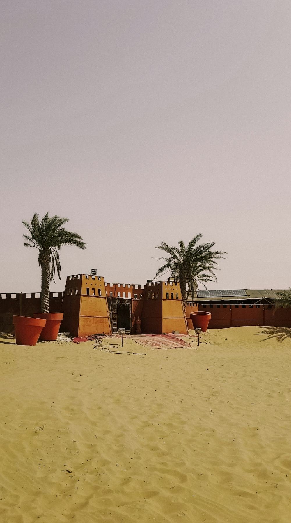 Al Jahili Fort in Al Ain, with palm trees in front of its walls.